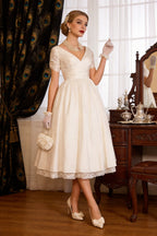1950s vintage short A-line wedding dress with V-neck, sleeves, lace and tulle, tea-length hem